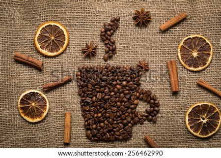 Coffee mug made from coffee beans with herbs and spices on burlab texture