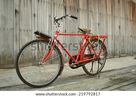 Red vintage  bikes and background wooden doors