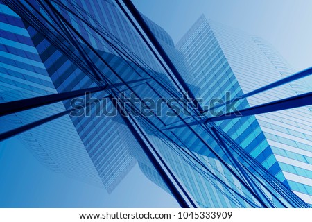Transparent modern architecture. Tilt double exposure photo of high-rise office building reflecting in glass wall of another office building. Abstract composition with geometric structure.