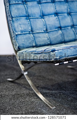 Detail of famous Barcelona chair, originally designed by Ludwig Mies van der Rohe and Lilly Reich, in blue jeans color