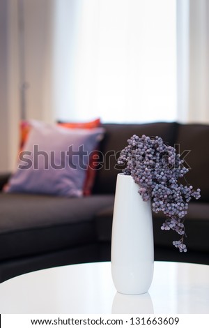 Modern White Vase With Violet Flower In Living Room