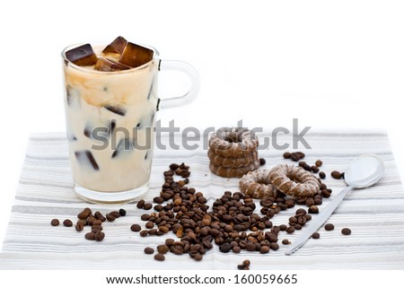 Home-made milky ice coffee with coffee beans and biscuits