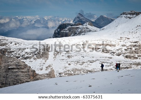 Group of friends walking in the snowy mountains