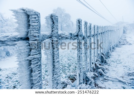 Rime covered fence by the ski-lift closed due to bad weather