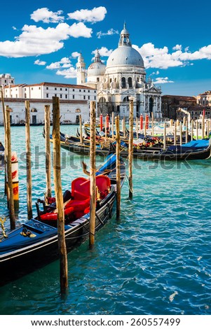 View of Grand Canal in Venice, Italy, with colorful gondola boats in the foreground