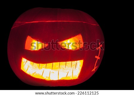 Halloween Jack o\'lantern. Pumpkin carved to create a scary face for Halloween.