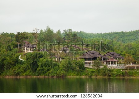 resort is on the mountain. Trapped near the river. Mountains with dense tree cover.