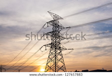 High voltage towers. The electric power industry and infrastructure. The sun is about to fall.