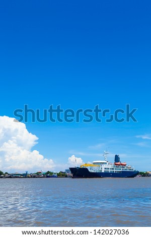 large cargo ship. Moored in the river. Space transportation industry.