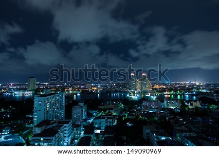 Bangkok city with tall buildings and small houses. The residential density at night.