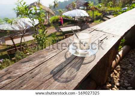 Coffee laid on wooden terrace In the early morning hours The sunlight shines down
