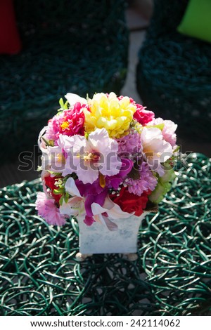 Vase of flowers on the table. Variety of colorful flowers arranged in a vase shape.