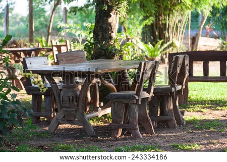Table and chairs on the lawn. In the space relaxation with tropical trees.