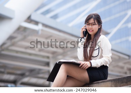 Businesswoman talking phone. Happy while talking on the phone.