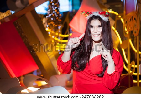 Santa woman dressing. Smiling and active. Is decorated with lights that happy during Christmas.