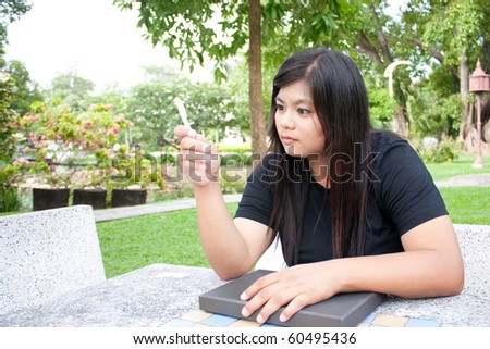 the woman thinking in the park, the black long hair woman