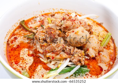 Thai noodle soup in a bowl on a white background taste spicy noodle soup.