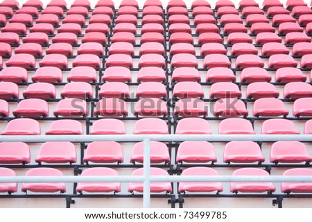 Red chairs on the miraculous. To watch a sporting event in the field.