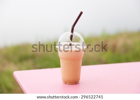 Coffee in plastic cup. Iced coffee in a plastic cup is placed on the table.
