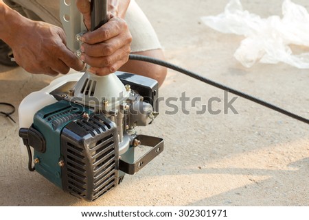 A man assemble brush cutter engine