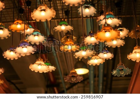 Warm lamps against cold lighting in a coffee shop