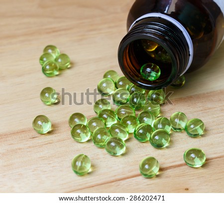 Supplement food,Vitamin E capsule on wooden table.