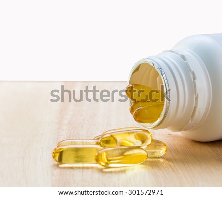 Evening primrose oil capsule on wood,supplementary food