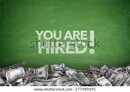 You are hired on green blackboard with pile of dollars