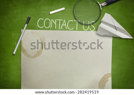 Contact us and blank paper concept on green full frame blackboard with magnifying glass