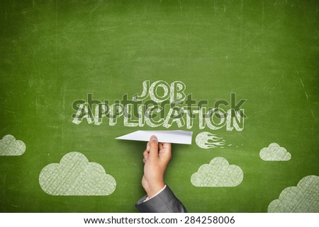 Job application concept on green blackboard with businessman hand holding paper plane