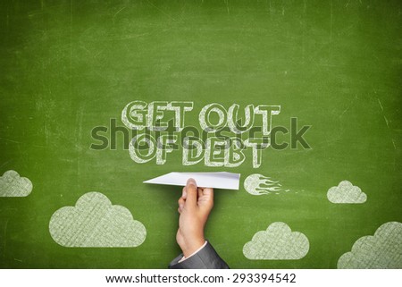Get out of debt concept on green blackboard with businessman hand holding paper plane