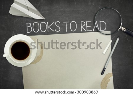 Books to read concept on black blackboard with empty paper sheet and coffee cup