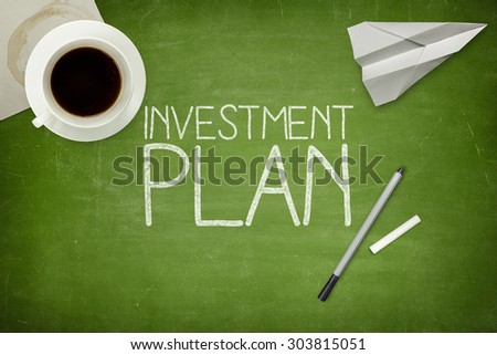 Investment plan concept on green blackboard with coffee cupt and paper plane