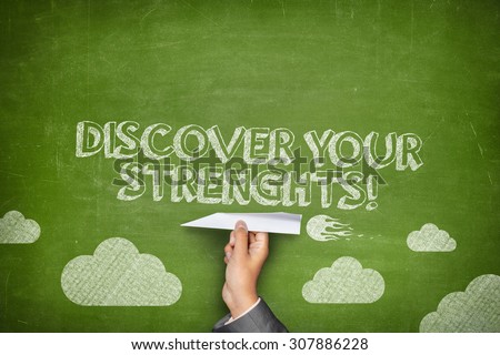 Discover your strenghts concept on green blackboard with businessman hand holding paper plane