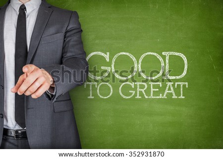 Good to great on blackboard with businessman finger pointing
