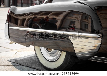 close-up of the front of the right rear of a black vintage car