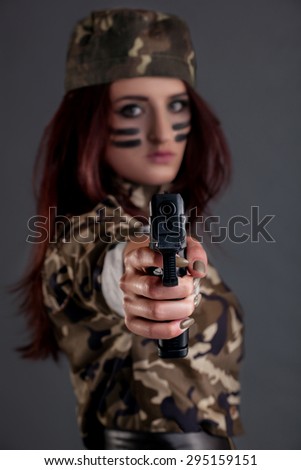 Girl in military style, which targeted a gun barrel