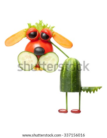 Funny dog made of cucumber, tomato, carrot and salad