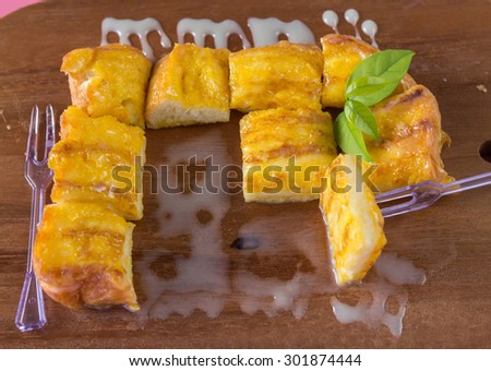 french toast with butter and milk on Wooden background