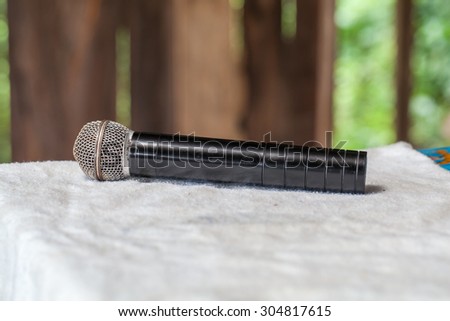 Old black microphone on the table.