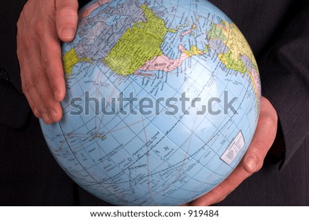 A Business Man Holding A Globe