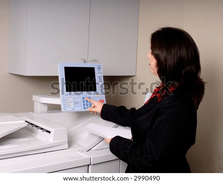 Young Woman Photocopying Some Documents In An Office Setting