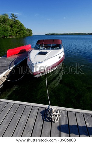 Cabin Cruiser Boat Tied Up At The Cottage Dock On Lake Simcoe, Canada