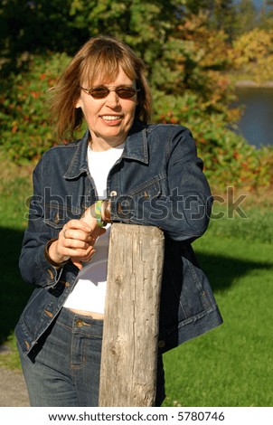 Middle Age Woman Dressed In Denim Jeans Outside On A Sunny Fall Day