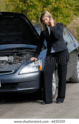 Businesswoman Beside Her Broken Down Car Making A Cellphone Mobile Call