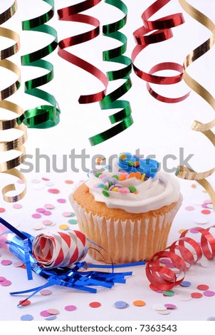 Cupcake With Party Streamers, Noise Makers And Confetti Ready For a Celebration