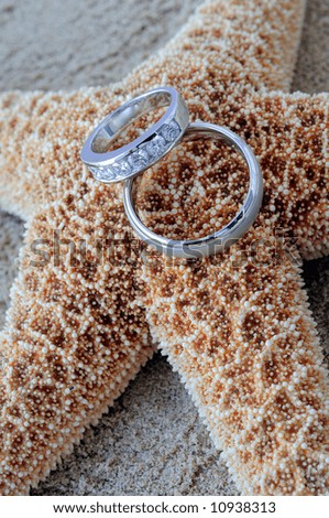 stock photo Starfish On A Caribbean Beach With Two Silver Wedding Rings