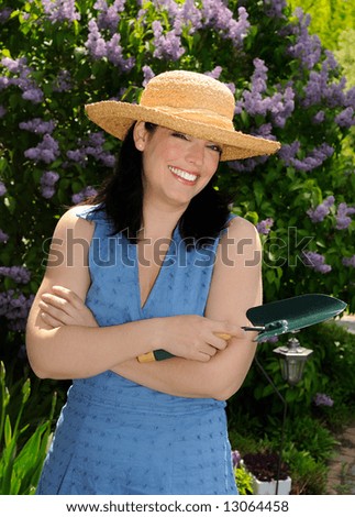 Happy Young Woman Gardening In The Springtime Sunshine