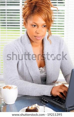 Beautiful Female Student Surfing The Web At An Internet Cafe