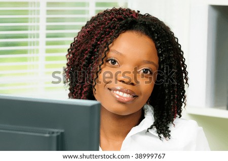 Beautiful Female African American Office Worker Sat At Her Computer